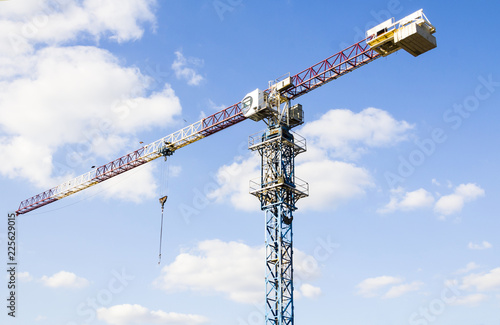 Obraz na płótnie Construction. Tower crane on the sky background. Crane w salonie