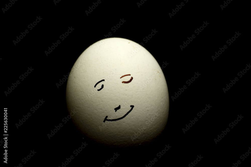 Egg represents human face isolated against black background Egg represents human face isolated against black background