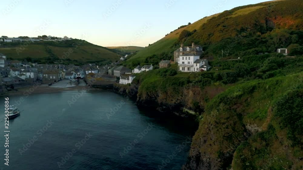 Drone flies sideways towards  cliffs in Port Isaac Cornwall