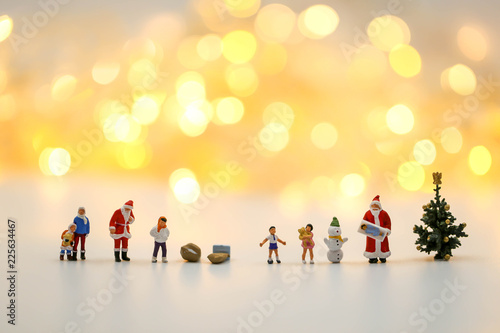 Merry christmas and happy new year Miniature People : Children with Santa Claus doll and his reindeer isolated on white background,in Christmas festival.