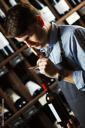 Sommelier smelling flavor of cork from red wine