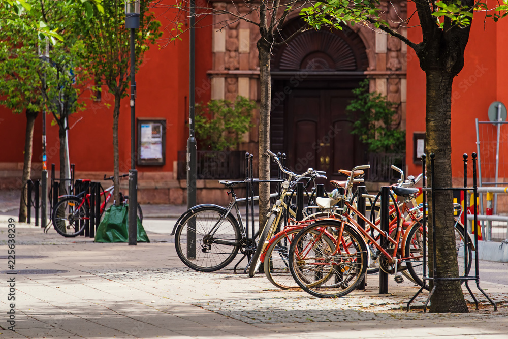 bicycles parked on bike parking on european old cobblestone city street. Stockholm, Sweden