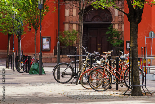 bicycles parked on bike parking on european old cobblestone city street. Stockholm, Sweden