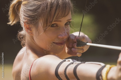 Woman practicing archery at boot camp