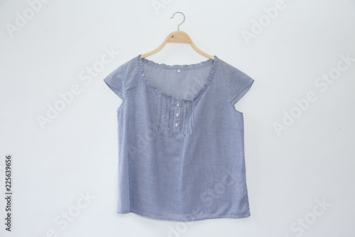 Natural colour blue clothes is clothes hanger on white background.close up