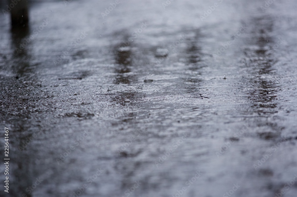 Rain drops falling on the road. Rain drops falling on the road.