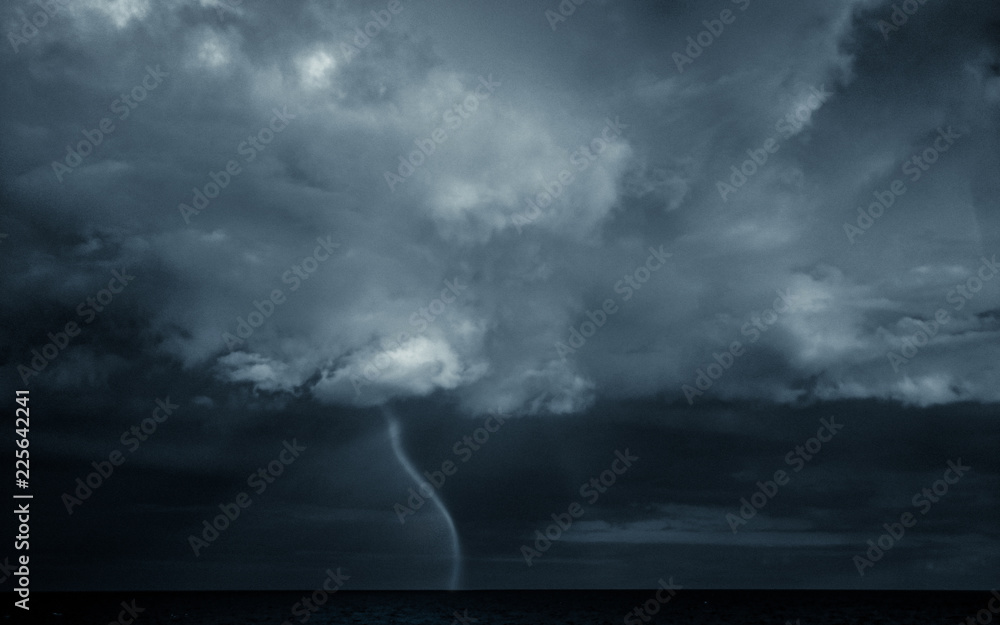 Ominous waterspout in a stormy sky. - obrazy, fototapety, plakaty 