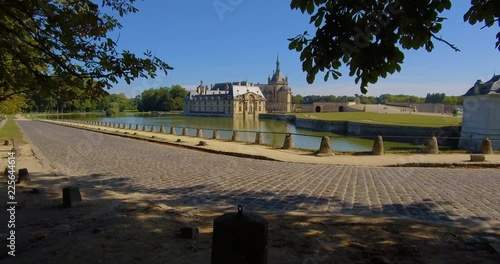 Reveal shot of the Ch√¢teau de Chantilly, as seen near the little lake. photo