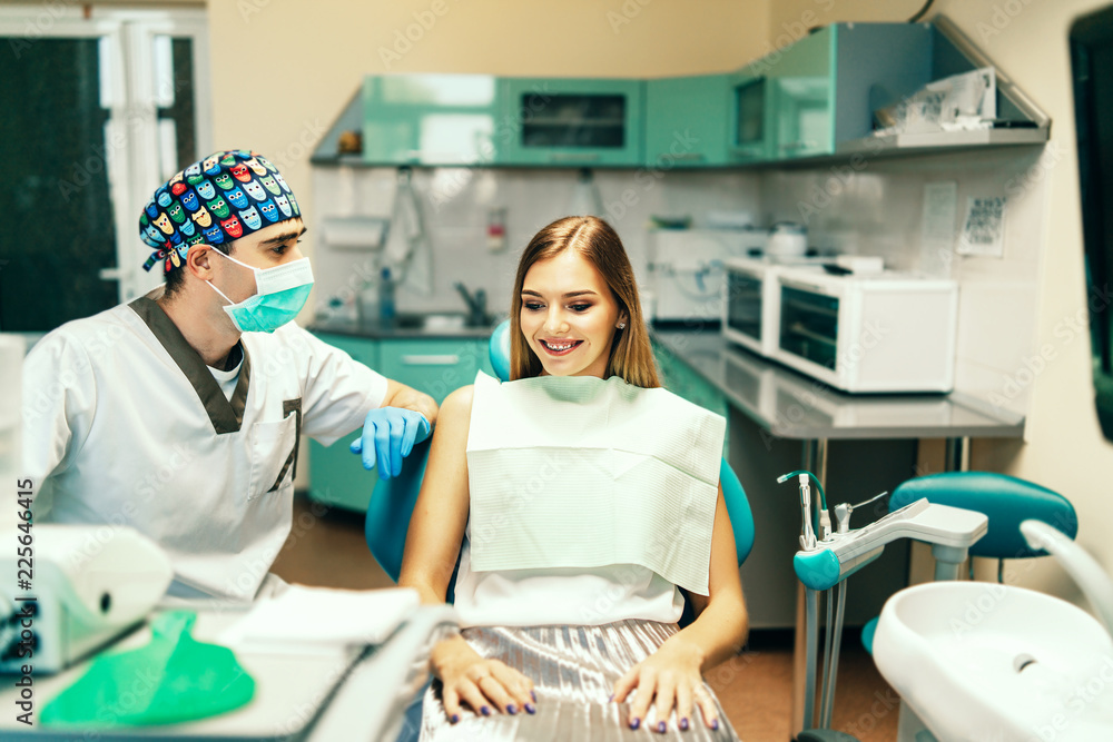Dentist examine female patient with braces in denal office. Dentist examine female patient with braces in denal office.