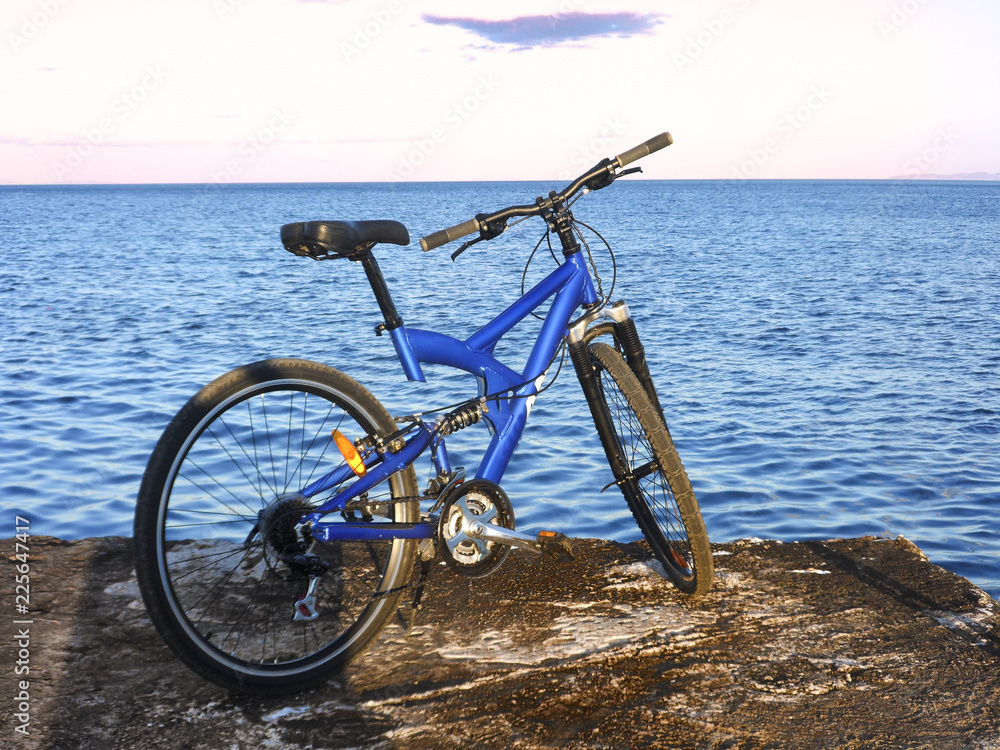 Fototapeta premium Mtb bike at the end of pier at sunset 