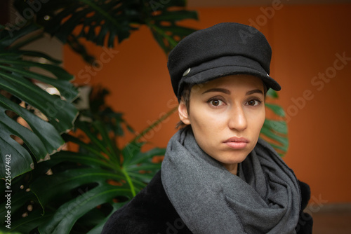 young woman in hat and scarf on the background of the jungle 