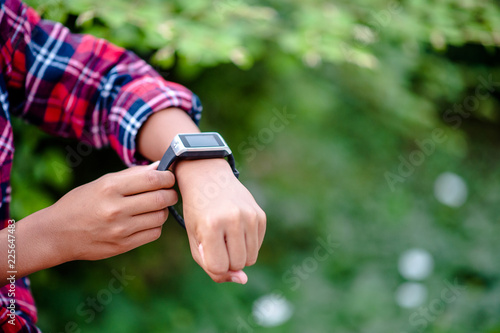 Hands and digital watches of boys Watch the time in the wrist. The orientation is punctual.