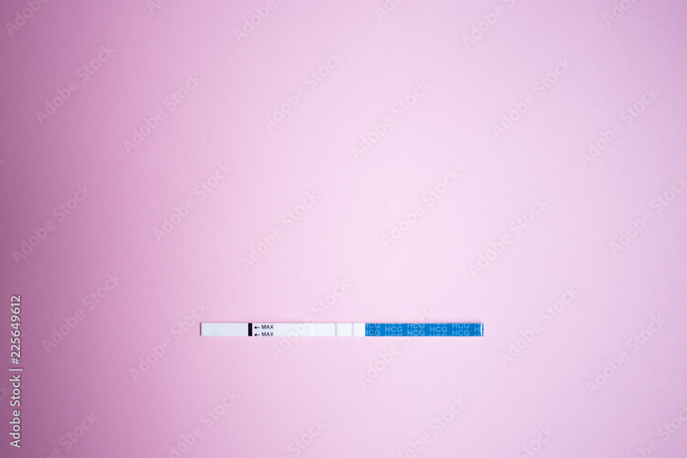 Positive pregnancy test with two strips. pink background, copy space Positive pregnancy test with two strips. pink background, copy space