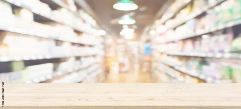 Wood table top with supermarket aisle blur background for product display