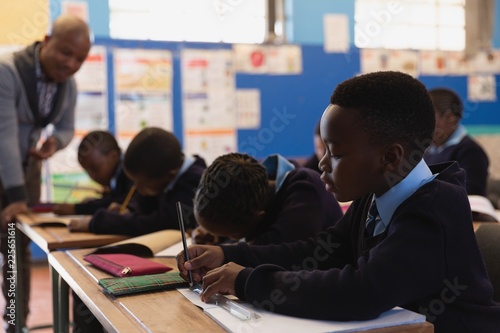 Male teacher teaching students in the class