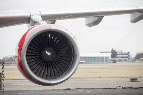 Aircraft engine on the wing with a red stripe