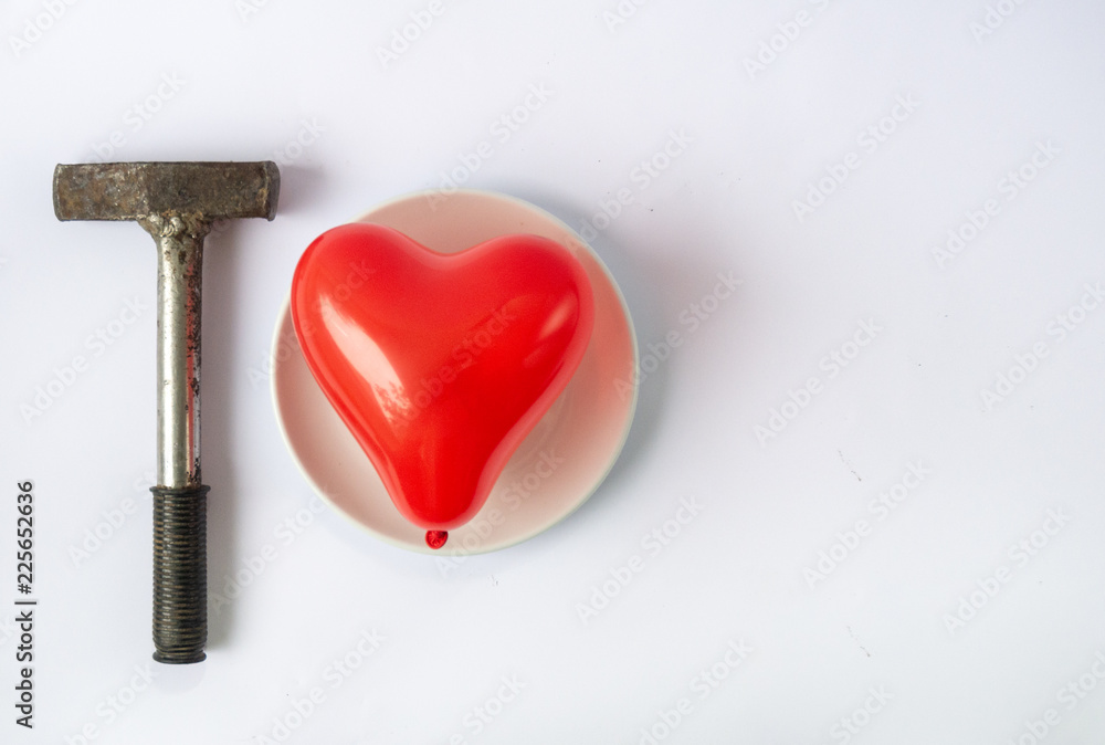 Red heart and hammer. Difficult love and relationship concept. Broken heart,  lost love. Stock Photo | Adobe Stock