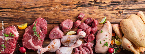 Assortment of raw meat on wooden table
