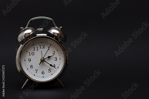 Retro alarm clock in dark background.For time concept.