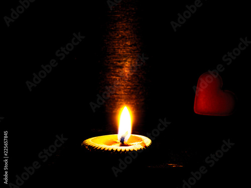 lighting candle and heart at night time.