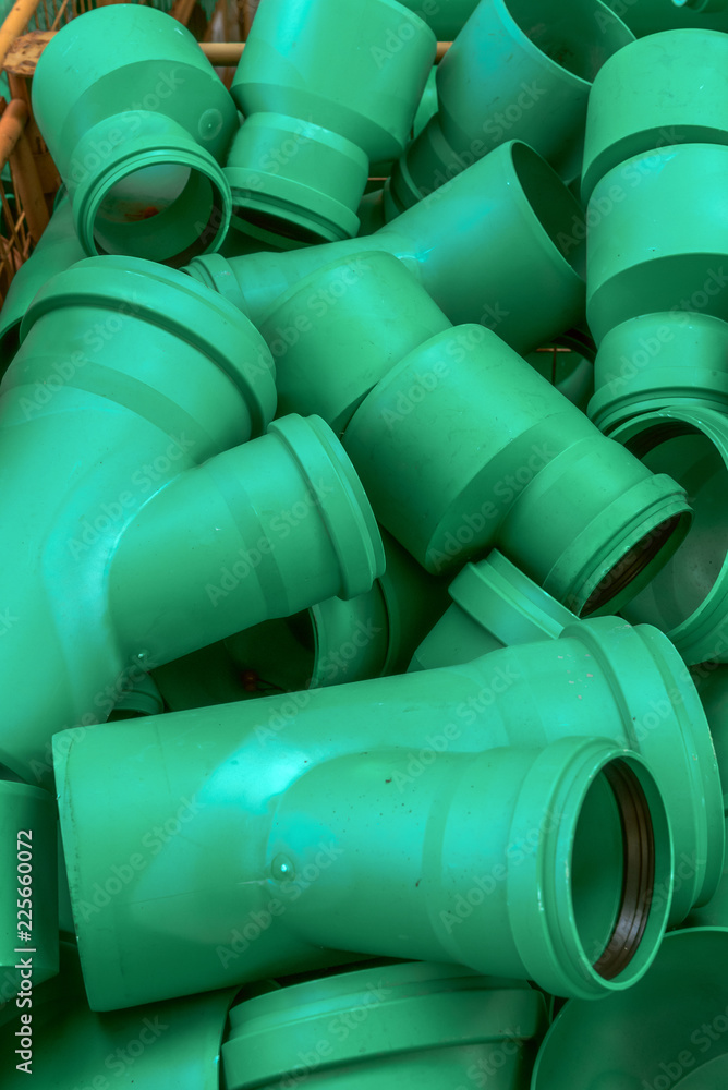Connectors of plastic green water pipes of different sizes. Concept: prevention or technology Connectors of plastic green water pipes of different sizes. Concept: prevention or technology
