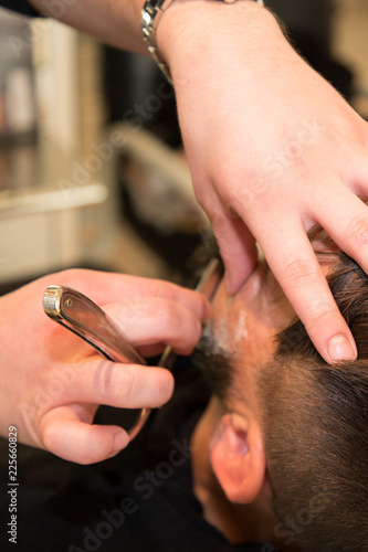 Hipster client visiting barber shop guy sitting at beauty salon