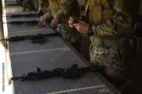 Military soldiers loading bullets in magazine