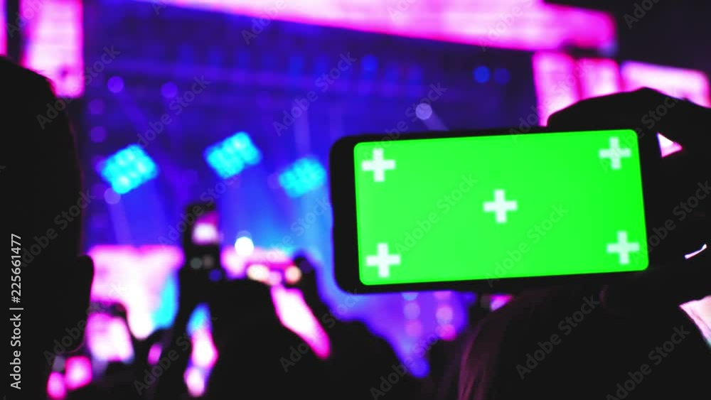 Smartphone green screen closeup concert party background technology innovation concept Smartphone green screen closeup concert party background technology innovation concept