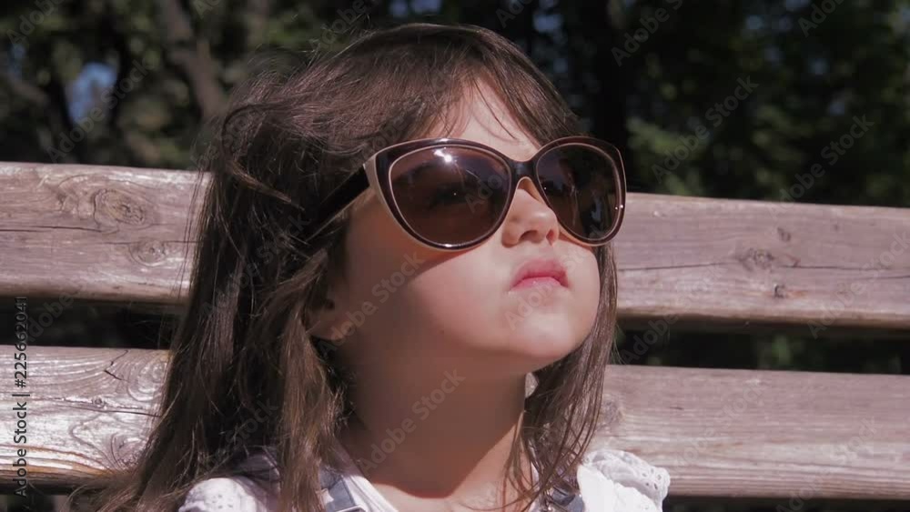 A child with a lollipop. Mother gives daughter candy. A child with a lollipop. Mother gives daughter candy.