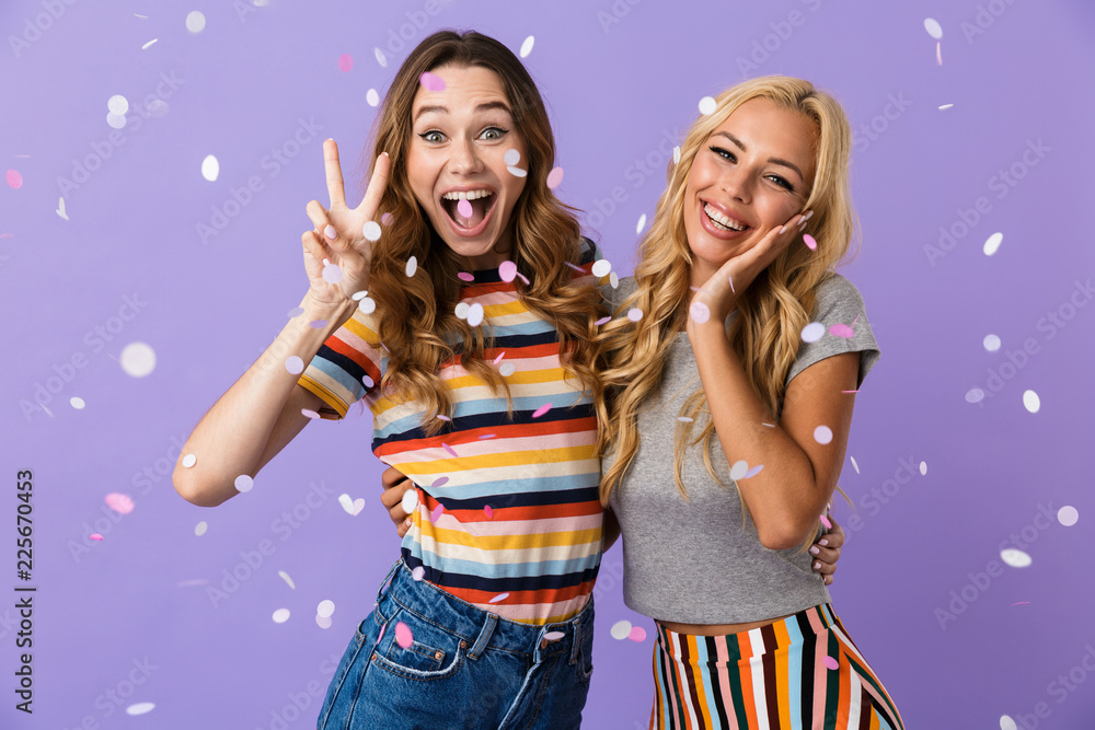 Two pretty young girls friends standing isolated Two pretty young girls friends standing isolated