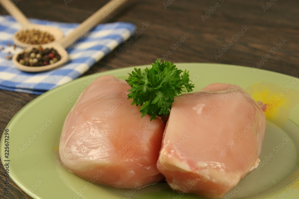 Raw chicken breast and spices close up. Selective focus Raw chicken breast and spices close up. Selective focus
