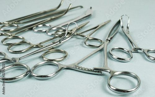 Medical surgical Instruments on blue background. Selective focus
