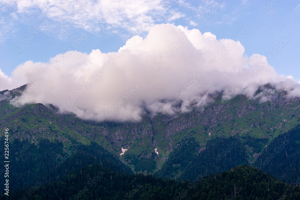 clouds on the peaks of the Caucasus mountains in summer