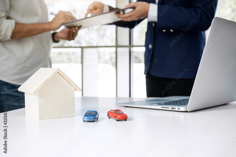 Car and Home for rent concept, broker agent presenting and consult to customer to decision making sign form agreement, home and car model