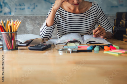 Young student sitting at desk in home studying and reading, doing homework and lesson practice preparing exam to entrance, education concept photo
