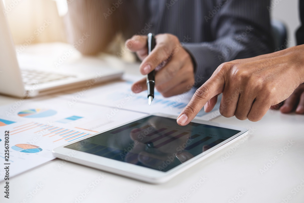 Fototapeta premium Co working conference, Business team meeting present, investor colleagues discussing new plan financial graph data on office table with laptop and digital tablet, Finance, accounting, investment