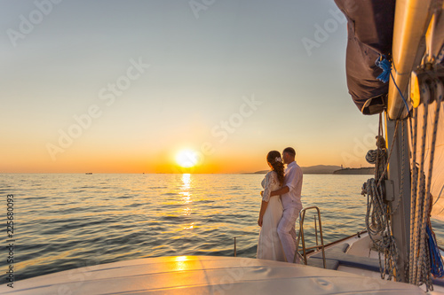 wedding couple travel on yacht at sunset