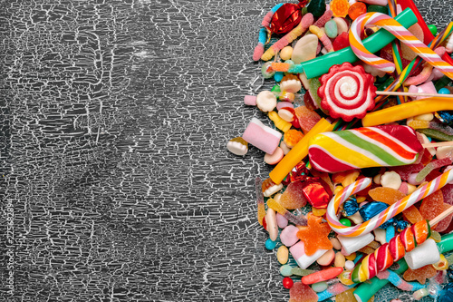 Colorful candies on old background