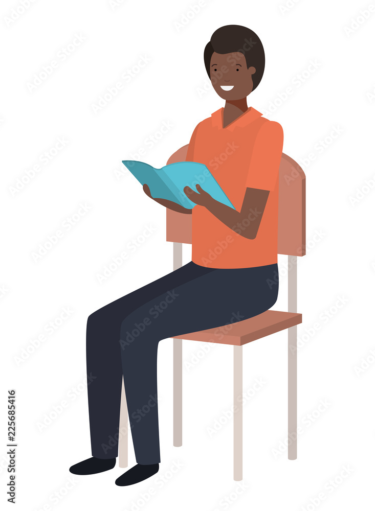 black man sitting in school chair reading book black man sitting in school chair reading book
