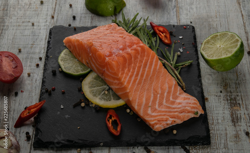 Konstfotografi fresh salmon on a black stone plate. with elasticity and limy