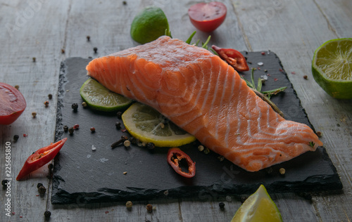 fresh salmon on a black stone plate. with elasticity and limy