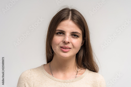 Portrait of a beautiful happy brunette girl on a white background.