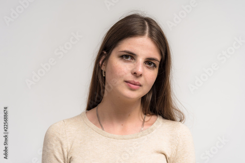 Portrait of a beautiful happy brunette girl on a white background. © Вячеслав Чичаев