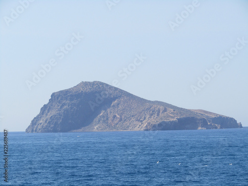 Capdolo island and waves and rocks