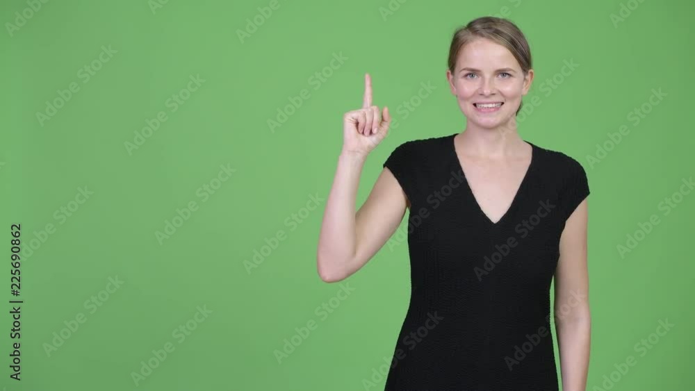 Young happy beautiful businesswoman thinking while pointing up Young happy beautiful businesswoman thinking while pointing up