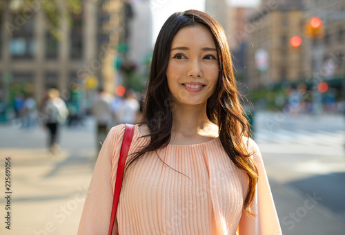 Принти на полотні Asian woman in city walking smile happy face
