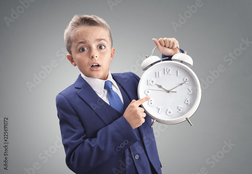 Time on clock shocked and surprised late young executive businessman boy photo