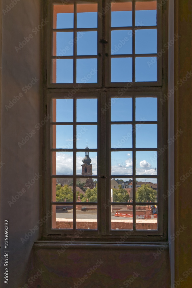 View through the antique window to the old city. View through the antique window to the old city.