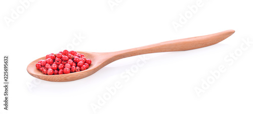 Red peppers in wooden spoon on white background