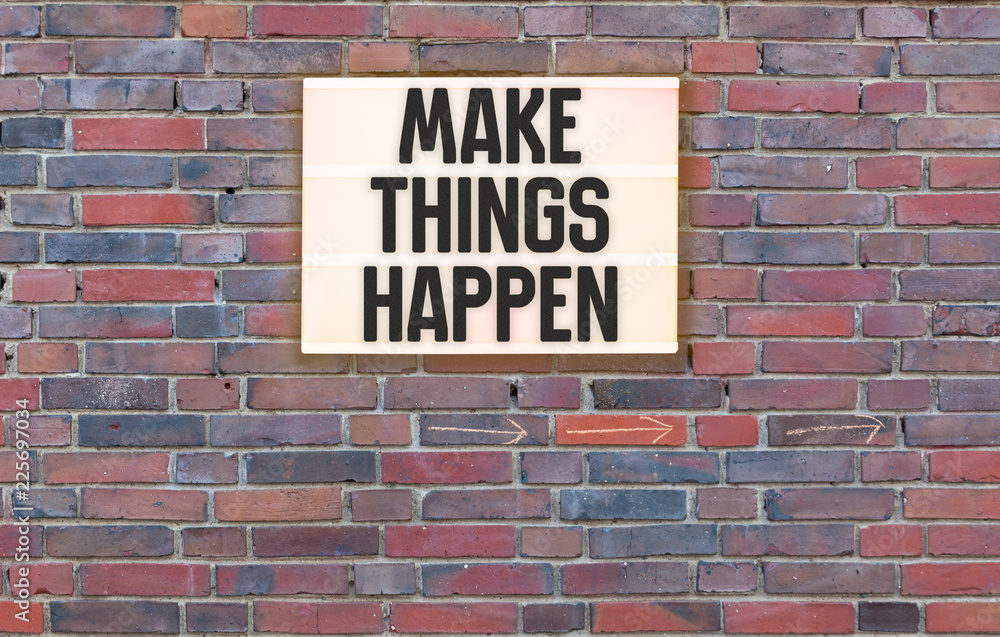 Make Things Happen message on Brick wall with light box